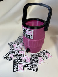 Pink breast cancer awareness cooler with black handle and spout beside a pile of ribbon emblem tags
